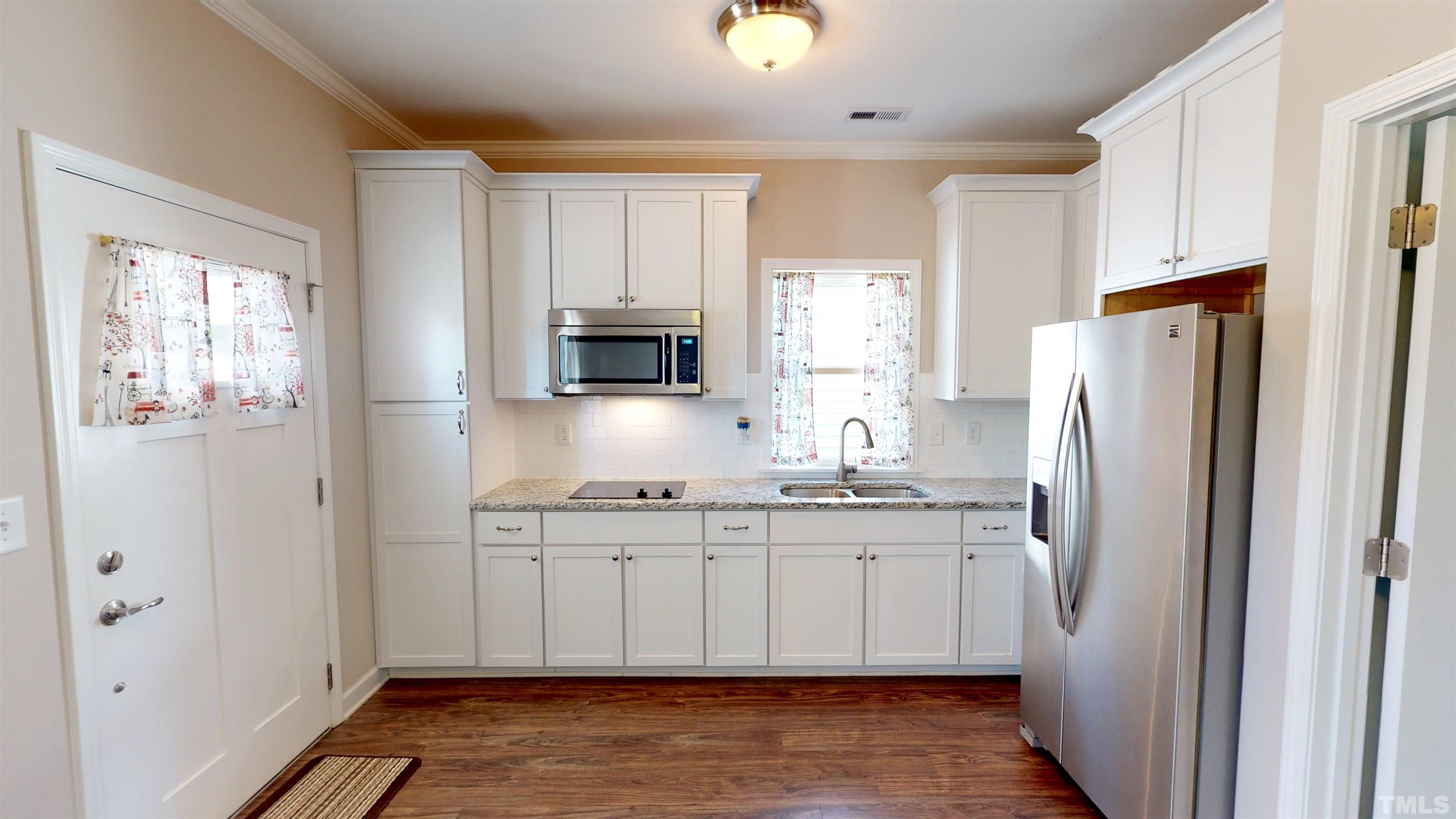 11250 Old Beulah Road Kenly, NC 27542 - Photo 50 of 66 a kitchen with stainless steel appliances a refrigerator sink and microwave