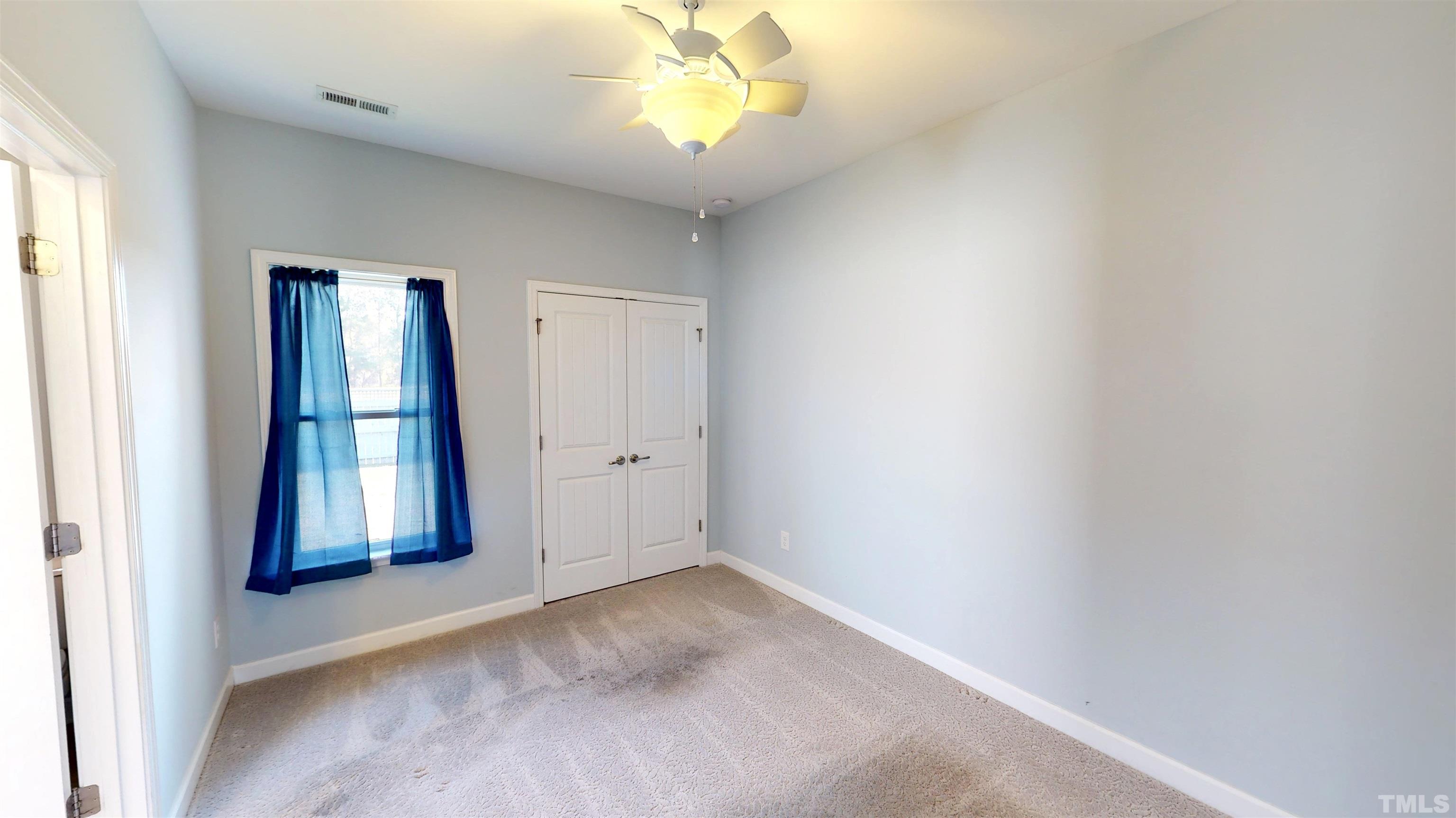 11250 Old Beulah Road Kenly, NC 27542 - Photo 53 of 66 an empty room with windows and closet