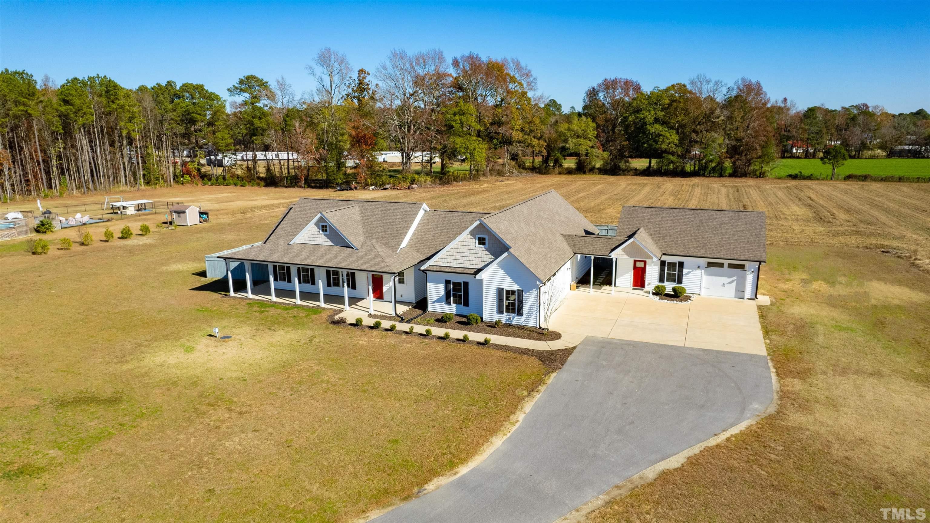 11250 Old Beulah Road Kenly, NC 27542 - Photo 66 of 66 an aerial view of a house with swimming pool and large trees