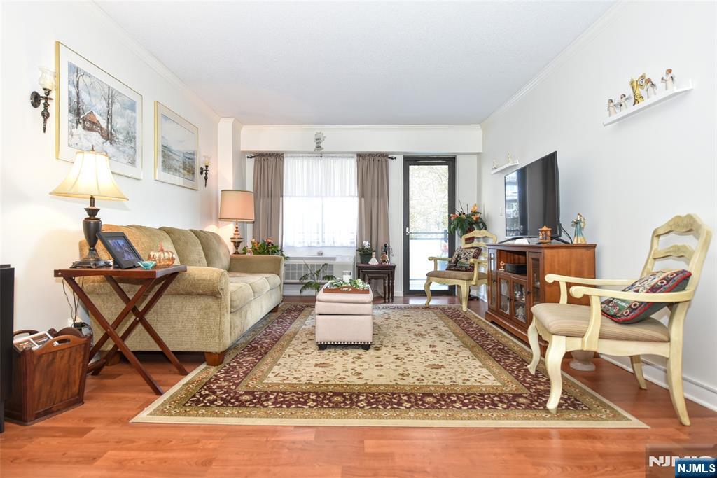 125 Prospect Avenue, Unit 3J Hackensack, NJ 07601 - Photo 12 of 25 a living room with furniture and a flat screen tv