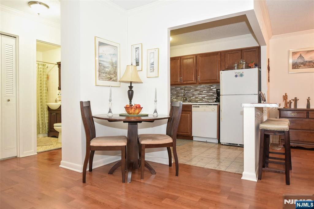 125 Prospect Avenue, Unit 3J Hackensack, NJ 07601 - Photo 14 of 25 a dining room with furniture and wooden floor