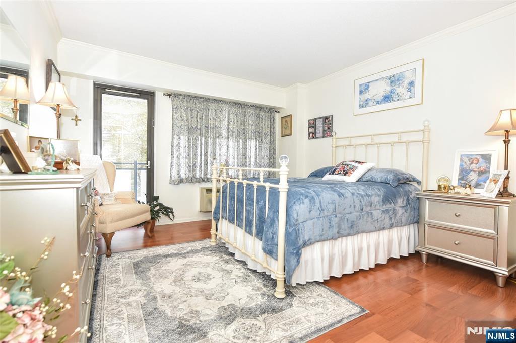 125 Prospect Avenue, Unit 3J Hackensack, NJ 07601 - Photo 17 of 25 a bedroom with a bed and a large window