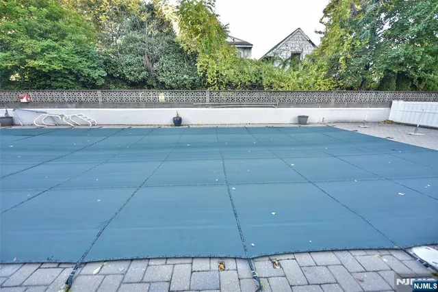 a view of a green field with trees in the background