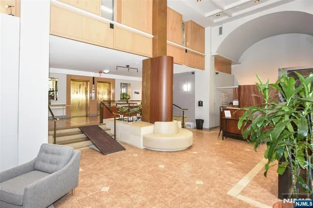 a lobby with furniture and a potted plant