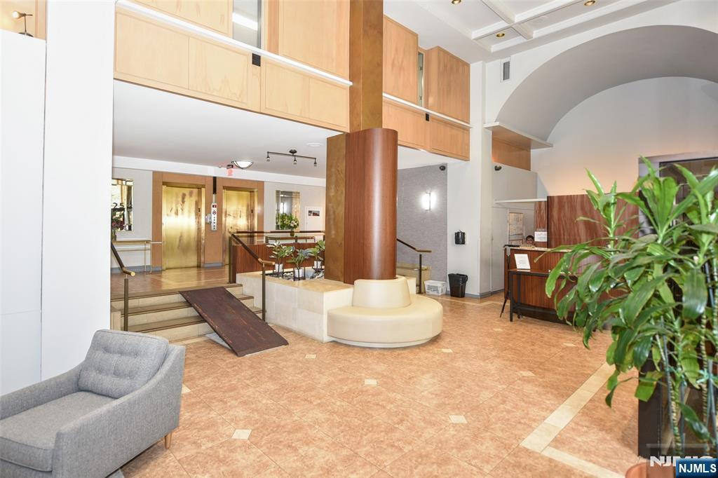 125 Prospect Avenue, Unit 3J Hackensack, NJ 07601 - Photo 7 of 25 a lobby with furniture and a potted plant