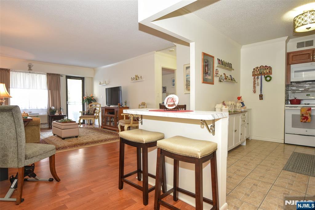 125 Prospect Avenue, Unit 3J Hackensack, NJ 07601 - Photo 10 of 25 a view of a dining room with furniture and a livingroom