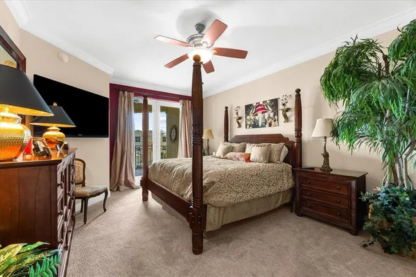 a bedroom with a bed and a chandelier