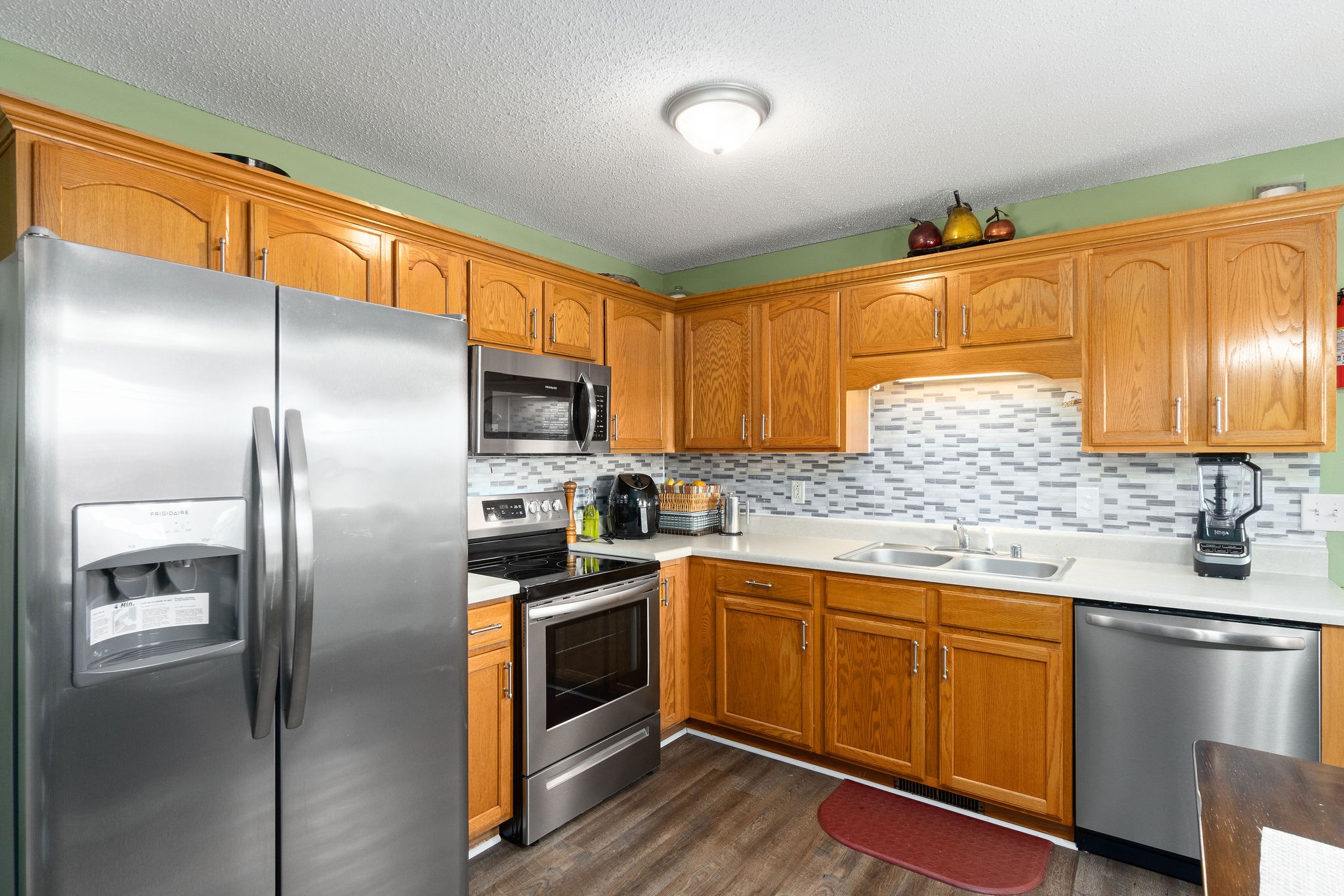 615 Avondale Road Oak Grove, KY 42262 - Photo 7 of 35 a kitchen with a sink stainless steel appliances wooden floor and cabinets
