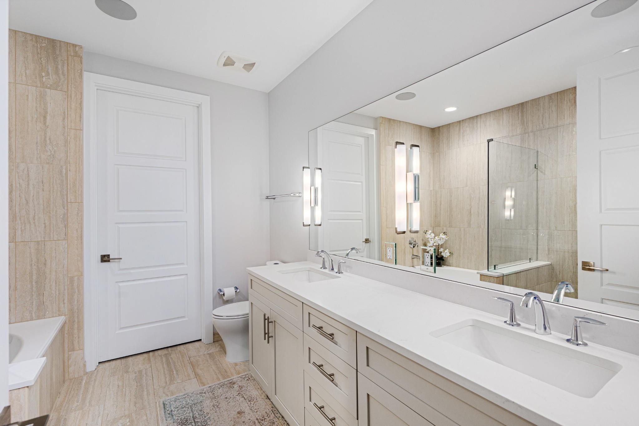 20 Rutledge Street, Unit 508 Nashville, TN 37210 - Photo 19 of 47 a spacious bathroom with a double vanity sink a mirror and a toilet
