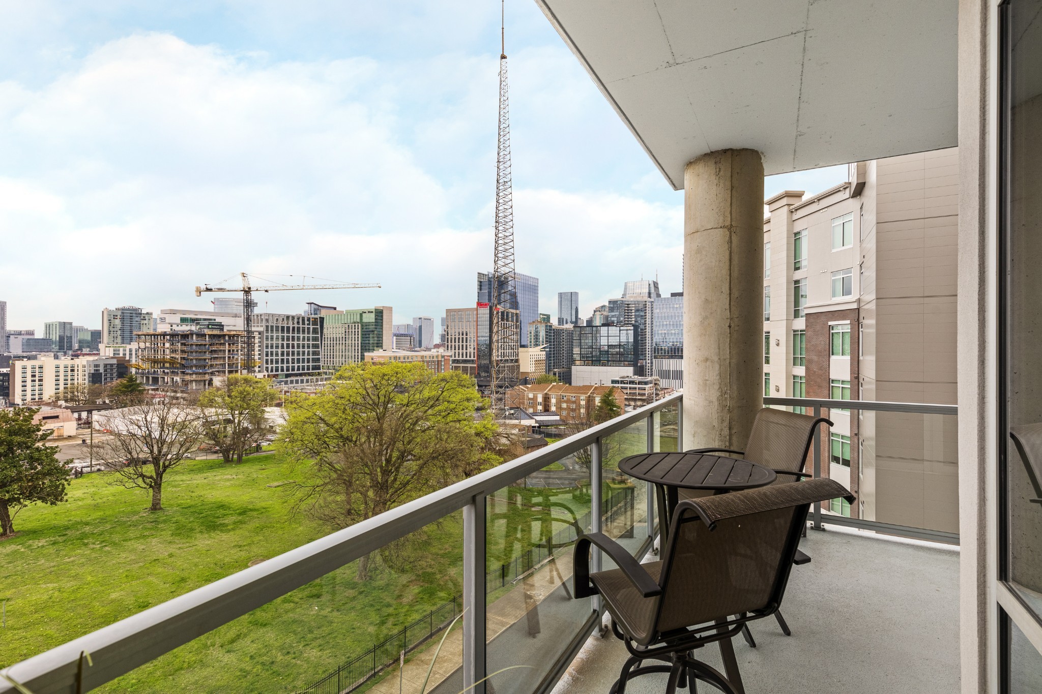 20 Rutledge Street, Unit 508 Nashville, TN 37210 - Photo 23 of 47 a view of a city from a balcony with furniture