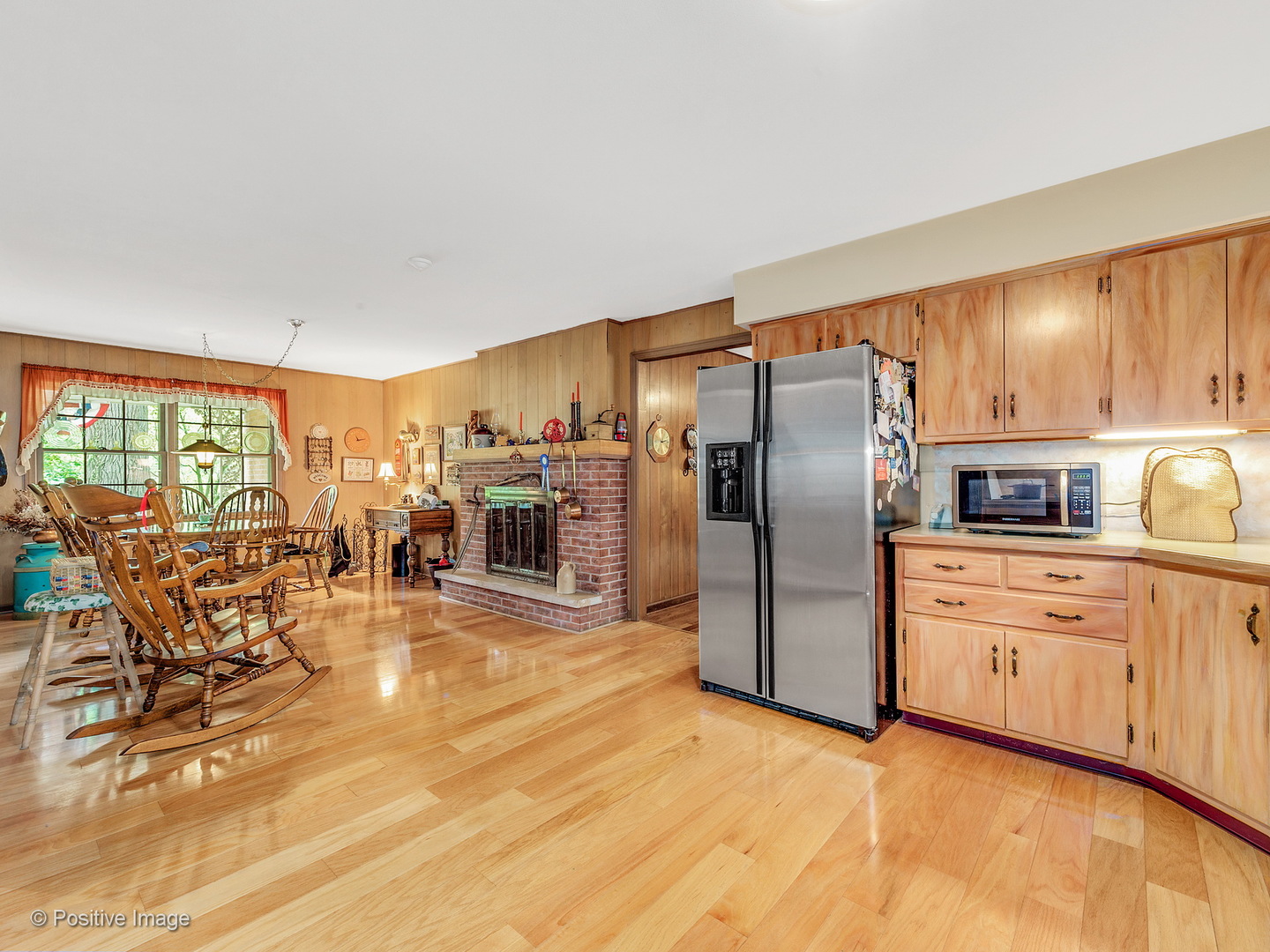S206 Summit Drive Winfield, IL 60190 - Photo 10 of 34 a kitchen with stainless steel appliances granite countertop a refrigerator a stove a sink a dining table and chairs with wooden floor