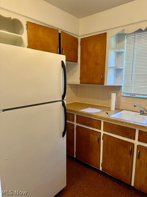 751 Thayer Street, Unit DOWN Akron, OH 44310 - Photo 8 of 25 Kitchen featuring decorative backsplash, white refrigerator, and sink