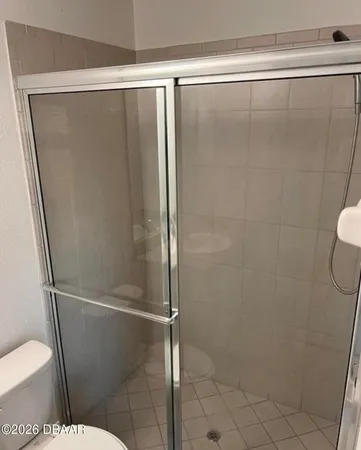 a bathroom with a glass shower door
