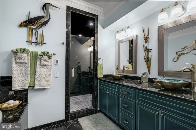 a kitchen with stainless steel appliances kitchen island granite countertop a table chairs and a refrigerator