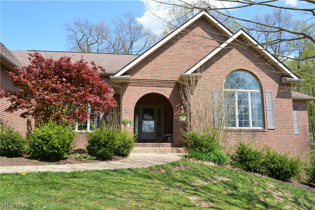 2363 Tabor Ridge Road Northeast New Philadelphia, OH 44663 - Photo 2 of 42 Brick exterior featuring an arched entry, prominent arched window, and gabled roofline