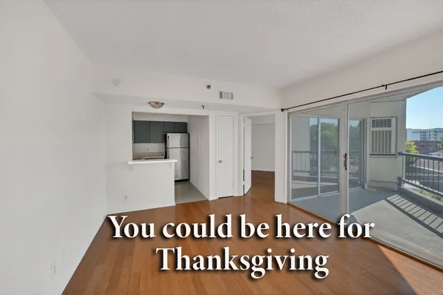 a kitchen with a refrigerator sink and cabinets