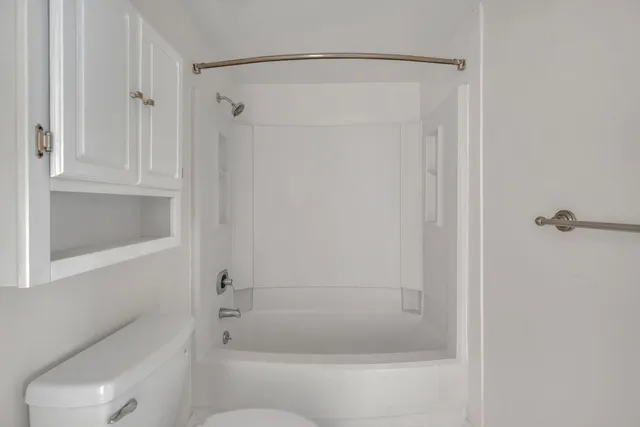 a bathroom with a shower and a toilet