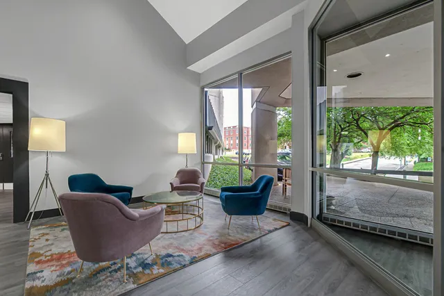 a living room with furniture and a potted plant