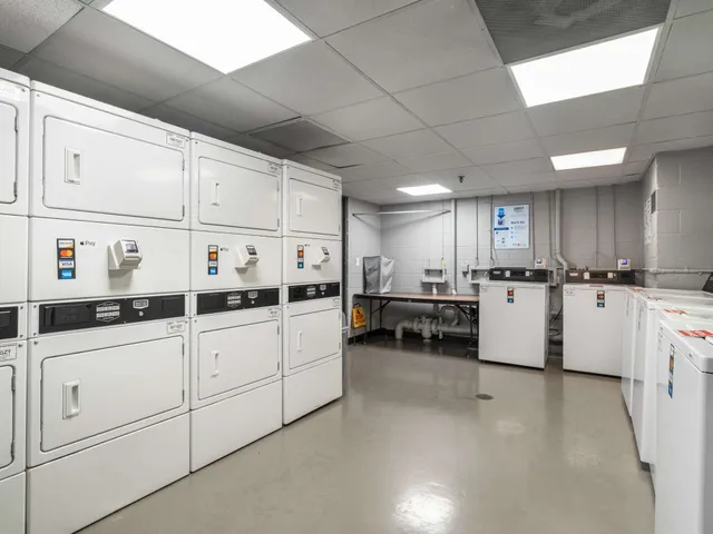 a kitchen with cabinets a sink and white appliances