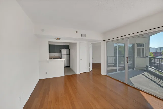 a big room with wooden floor and windows