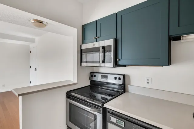 a kitchen with wooden cabinets and a stove top oven