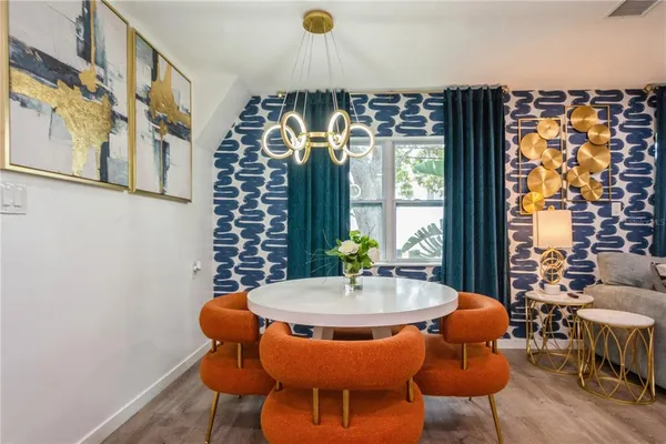 a view of a dining room with furniture window and wooden floor