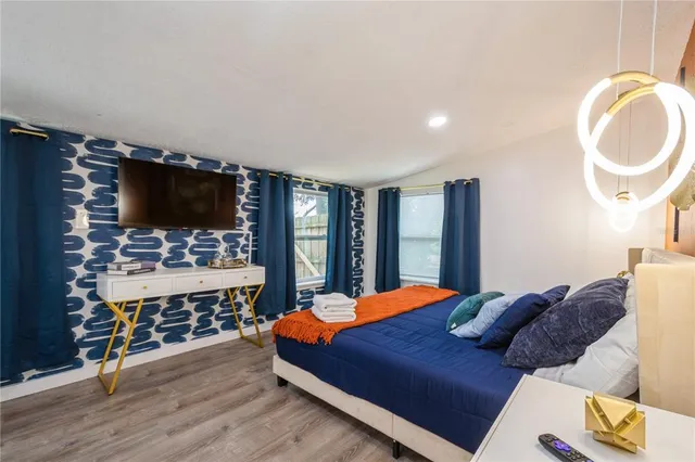 a bedroom with a bed and a flat screen tv