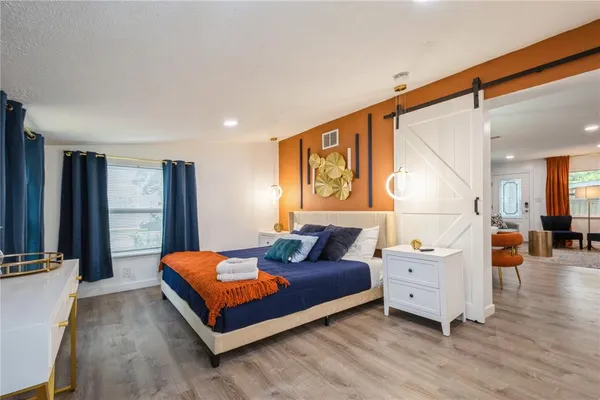 a bedroom with furniture and wooden floor