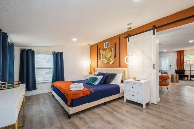 a bedroom with furniture and wooden floor
