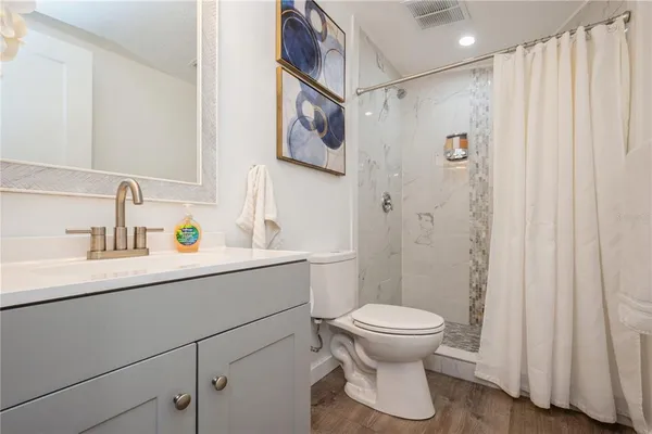 a bathroom with a sink toilet and shower
