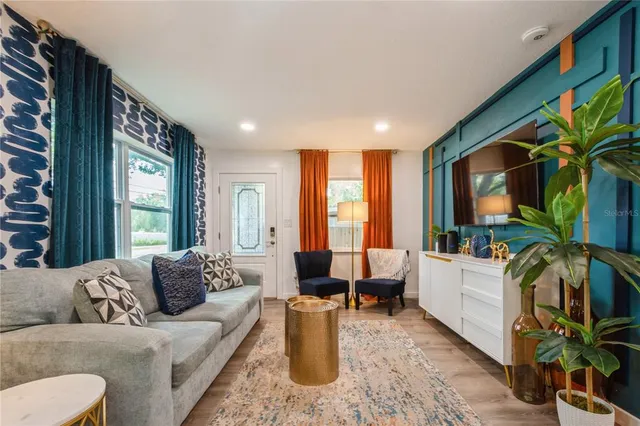 a living room with furniture and a flat screen tv