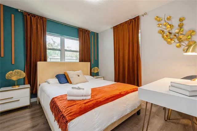 a bedroom with a bed and a window