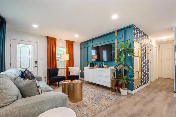 a living room with furniture and a flat screen tv