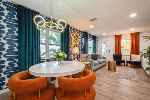 a living room with furniture a rug and a chandelier