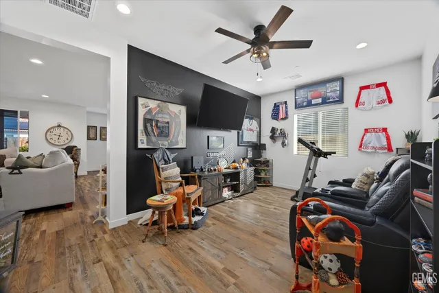 a living room with furniture and a wooden floor