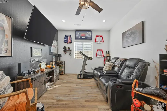 a living room with furniture gym equipment and a flat screen tv