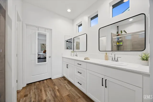 a bathroom with 2 sink and a mirror