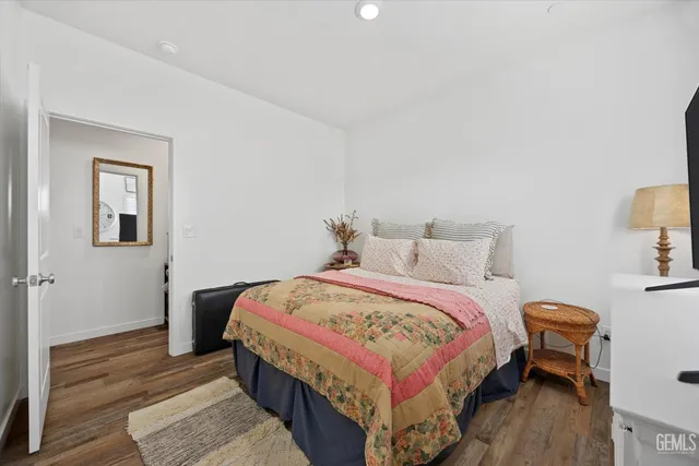 a bedroom with a bed and wooden floor