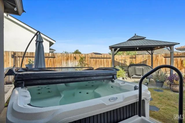 a backyard of a house with a fountain table and chairs