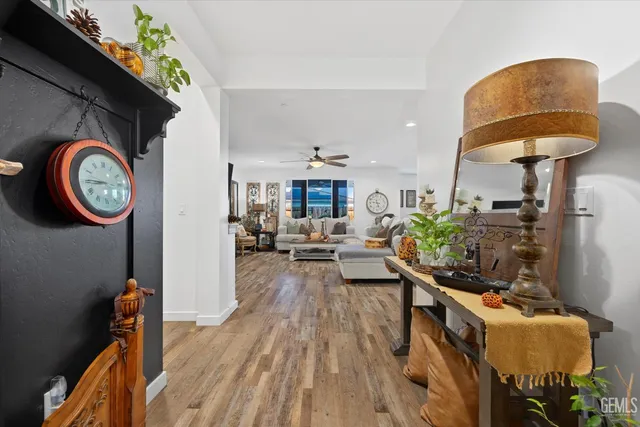 a living room with furniture a rug and a clock