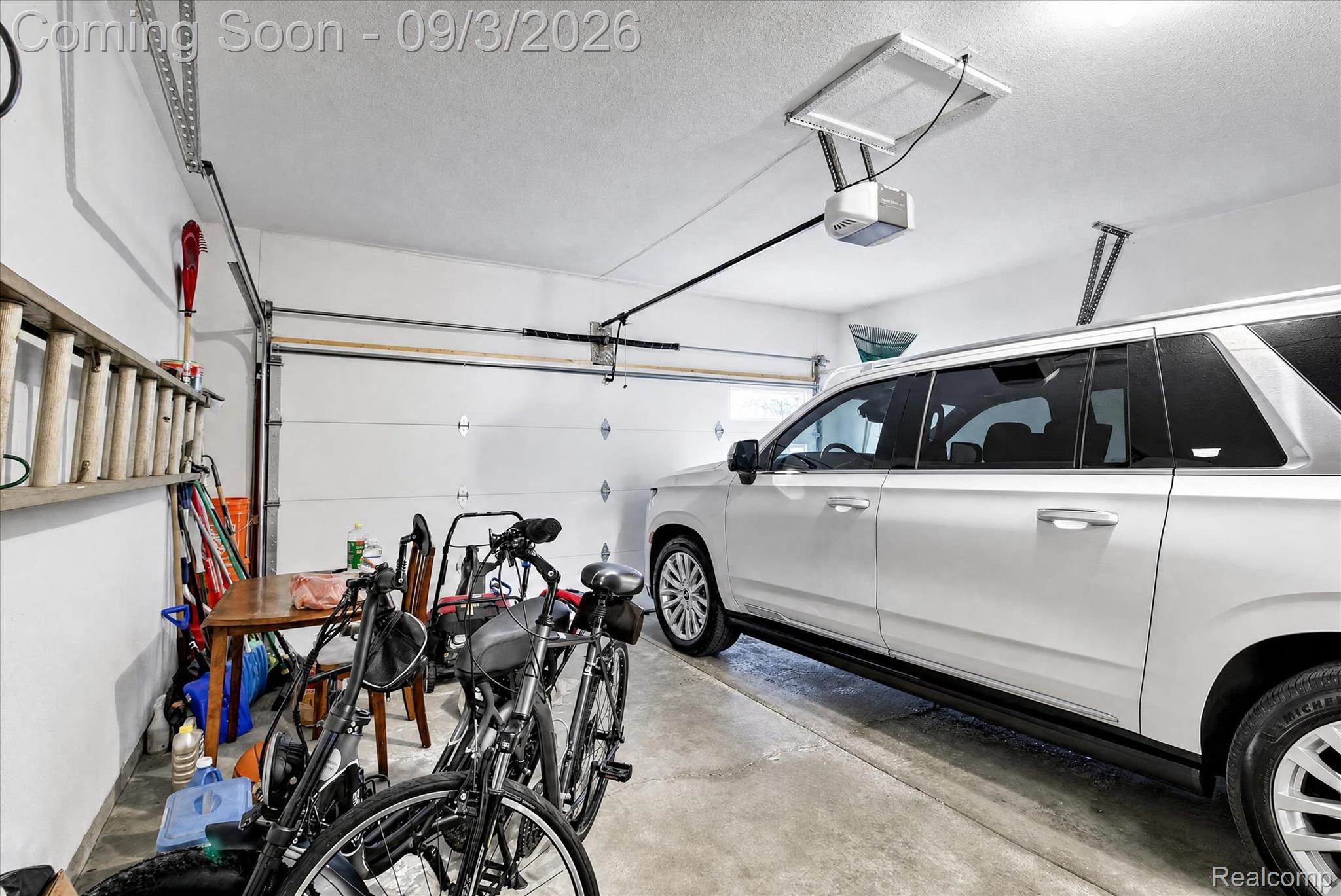 27260 Campbell Road Warren, MI 48093 - Photo 41 of 60 Attached garage with a white panel door, concrete flooring, and an automatic garage door opener