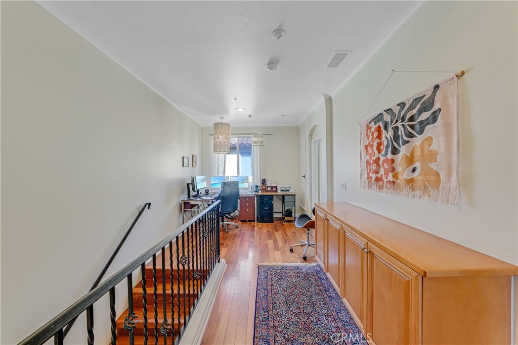 308 5th Street Huntington Beach, CA 92648 - Photo 30 of 41 a view of a hallway with wooden floor and stairs