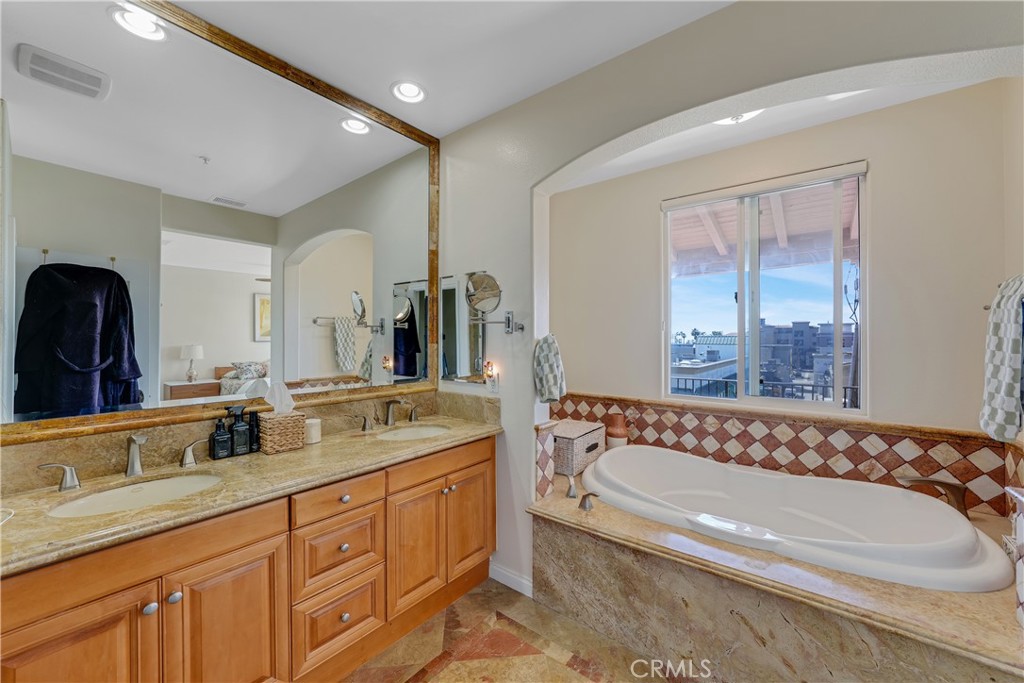 308 5th Street Huntington Beach, CA 92648 - Photo 35 of 41 a bathroom with a granite countertop tub sink and mirror
