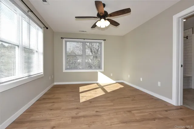 a bedroom with a bed couch and window