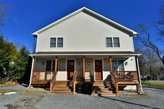 a view of a house with a large tree