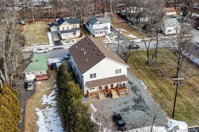 a porch with wooden floor in front of it