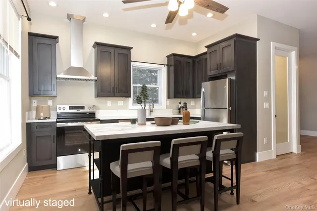 a kitchen with stainless steel appliances granite countertop a refrigerator stove and kitchen island