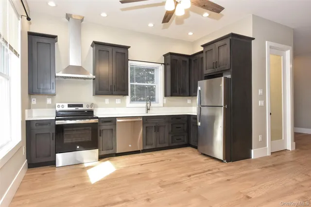 a kitchen with stainless steel appliances granite countertop a sink stove and refrigerator