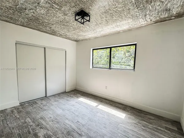 an empty room with a empty space and windows