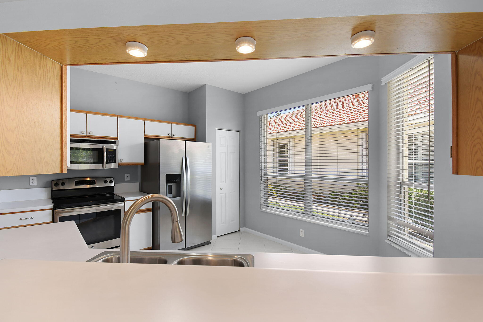 6785 Southeast Warwick Lane Stuart, FL 34997 - Photo 11 of 62 a kitchen with stainless steel appliances a sink and a refrigerator